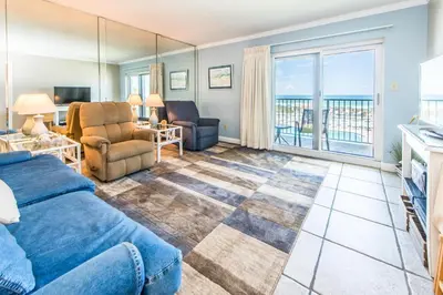 a living room with a couch and chairs and a balcony at Moonspinner 211B - PCB East in Panama City Beach