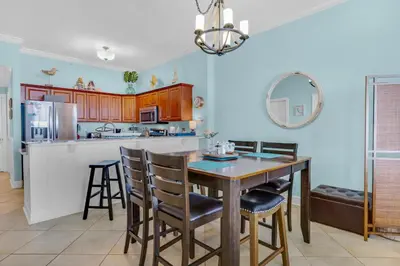 a kitchen with a table and chairs in a room at Ocean Villa Penthouse #2302 in Panama City Beach