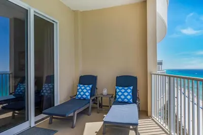 a balcony with chairs and a view of the ocean at Ocean Villa Penthouse #2302 in Panama City Beach