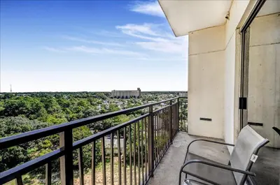 a chair sitting on a balcony with a view at Origin at Seahaven 825 in Panama City Beach