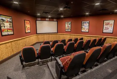 a lecture room with chairs and a screen at Origin at Seahaven 825 in Panama City Beach