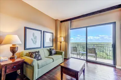 a living room with a couch and a large window at Origin at Seahaven 825 in Panama City Beach