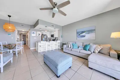 a living room with a couch and a table at Seychelles 1504 in Panama City Beach