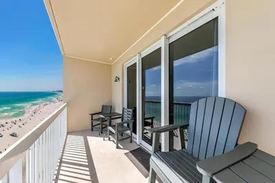 a balcony with two chairs and the beach at Seychelles 1504 in Panama City Beach