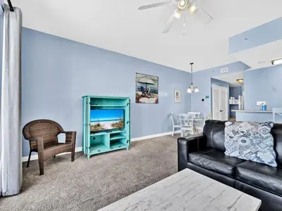 a living room with a couch and a table at Seychelles 207 in Panama City Beach