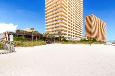 a sandy beach with tall buildings in the background at Seychelles 907 in Panama City Beach