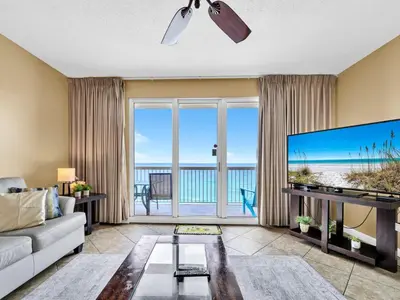 a living room with a large flat screen tv at Seychelles 907 in Panama City Beach