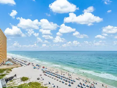 a beach with a lot of people and the ocean at Seychelles 907 in Panama City Beach