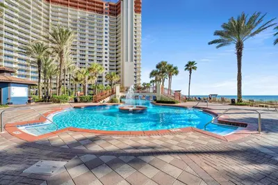 a swimming pool with a fountain in front of a building at Shores of Panama 2112 in Panama City Beach