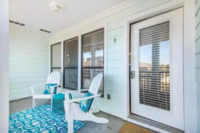 a pair of chairs on the porch of a house at Southwind I-9 in Panama City Beach