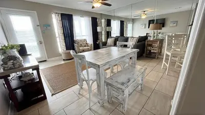 a dining room and living room with a table and chairs at Southwind I-9 in Panama City Beach