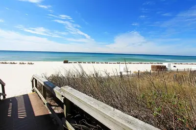 a wooden boardwalk leading to a beach with the ocean at Southwind I-9 in Panama City Beach