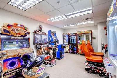 a room filled with lots of arcade games at Tidewater Beach Resort by Panhandle Getaways in Panama City Beach