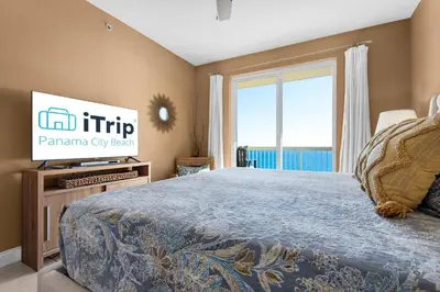 a bedroom with a large bed and a tv at Calypso Resort Tower 1 Unit 1606 (3/2) in Panama City Beach