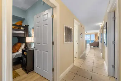 a hallway with a door leading to a bedroom at Calypso Resort Tower 1 Unit 1606 (3/2) in Panama City Beach