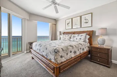 a bedroom with a bed with a view of the ocean at Grandview East 903 (3/2) in Panama City Beach