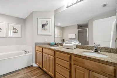 a bathroom with two sinks and a bath tub and a tubermott at Grandview East 903 (3/2) in Panama City Beach
