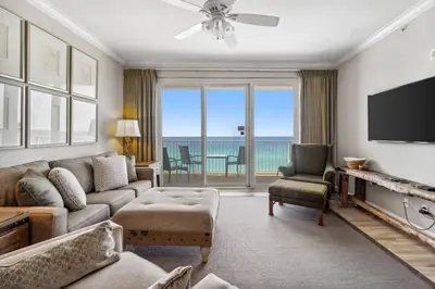 a living room with a couch and a flat screen tv at Grandview East 903 (3/2) in Panama City Beach