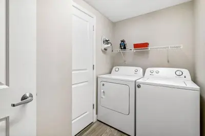 a white laundry room with a washer and dryer at Grandview East 903 (3/2) in Panama City Beach