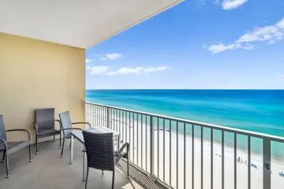 a balcony with chairs and a view of the ocean at Grandview East 903 (3/2) in Panama City Beach