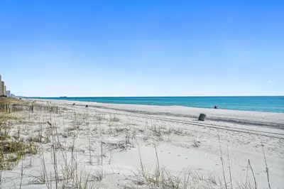 a sandy beach with the ocean in the background at Beachside West Townhome in Panama City Beach