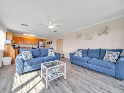 a living room with two blue couches and a table at Ramsgate 3 in Watersound Beach