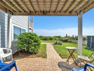 a patio with blue chairs and a table at Ramsgate 3 in Watersound Beach