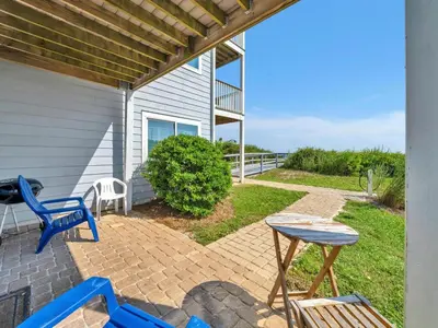 a patio with blue chairs and a table at Ramsgate 3 in Watersound Beach