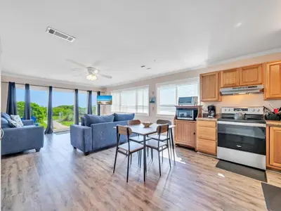 a kitchen and living room with a table and chairs at Ramsgate 3 in Watersound Beach