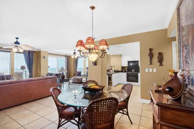 a dining room and living room with a table and chairs at Treasure Island 2212 in Panama City Beach