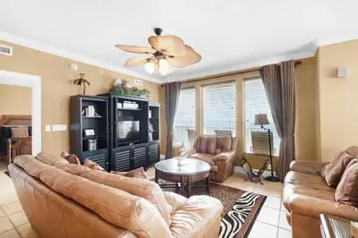 a living room with a couch and a tv at Treasure Island 2212 in Panama City Beach