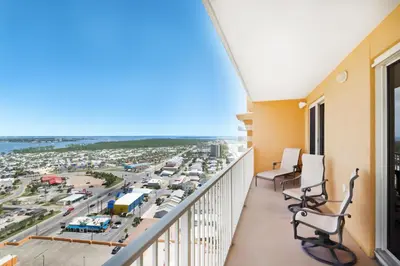 a balcony with chairs and a view of a parking lot at Treasure Island 2212 in Panama City Beach