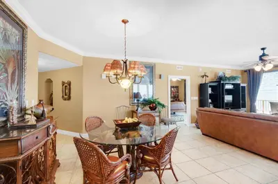 a dining room and living room with a table and chairs at Treasure Island 2212 in Panama City Beach