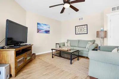 a living room with a flat screen tv and a couch at Aquavista 304W in Panama City Beach