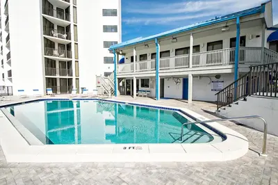 a swimming pool in front of a apartment building at Aquavista 304W in Panama City Beach