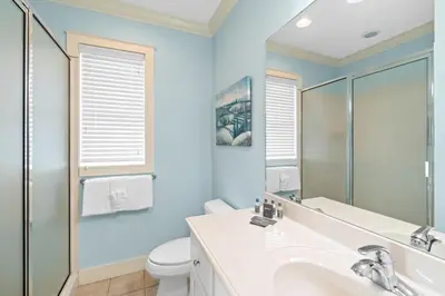 a bathroom with a sink and a toilet at La Valencia Villas in Rosemary Beach