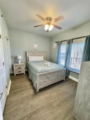 a bedroom with a bed and a ceiling fan at Shores of Panama Resort in Panama City Beach