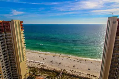 a view of the beach from the balcony of a building at Shores of Panama Resort in Panama City Beach