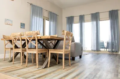 a dining room with a wooden table and chairs at Shores of Panama Resort in Panama City Beach