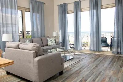 a living room with a couch and a table at Shores of Panama Resort in Panama City Beach