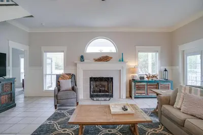 a living room with a fireplace and a table at 30A Beach House - Walking on Sunshine in Inlet Beach
