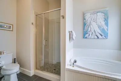 a bathroom with a bath tub and a toilet at 30A Beach House - Walking on Sunshine in Inlet Beach