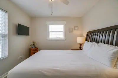 a bedroom with a large white bed and a window at 30A Beach House - Walking on Sunshine in Inlet Beach