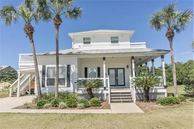 a white house with palm trees in front of it at 30A Beach House - Walking on Sunshine in Inlet Beach