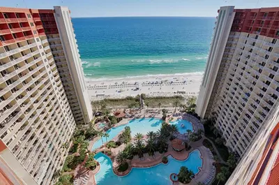 an aerial view of the beach between two buildings at Shores of Panama by Panhandle Getaways in Panama City Beach