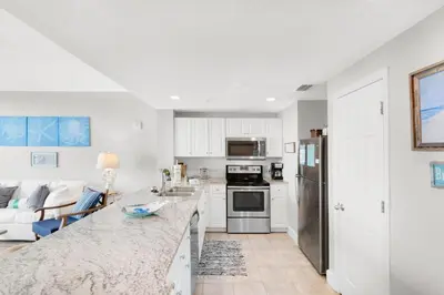 a kitchen with white cabinets and a counter top at Majestic Beach Towers 1-1006 in Panama City Beach