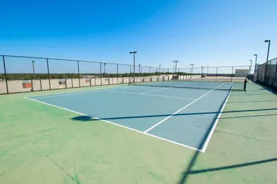 a tennis court with two tennis rackets on it at Majestic Beach Towers 1-1006 in Panama City Beach