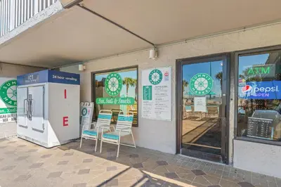 a store front with two chairs and a refrigerator at The Summit Beach Resort By Panhandle Getaways in Panama City Beach