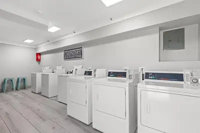 a row of washers and dryers in a laundry room at The Summit Beach Resort By Panhandle Getaways in Panama City Beach