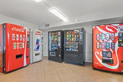 two cocacola machines and two soda machines in a store at The Summit Beach Resort By Panhandle Getaways in Panama City Beach